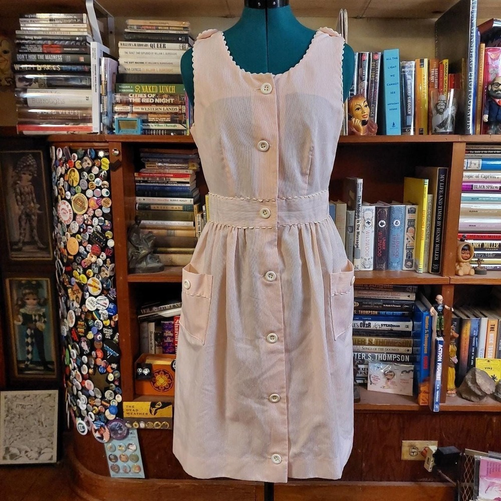 Vintage baby pink and white stiped dress with pockets and button detail.